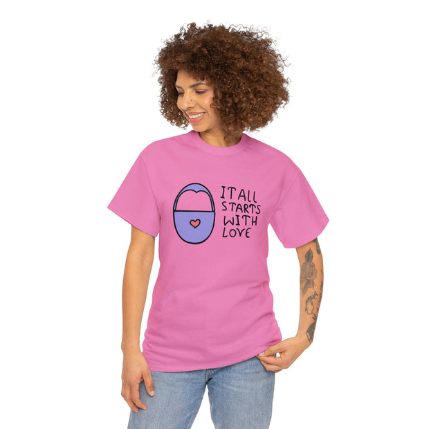 a woman wearing a pink t - shirt that says it all starts with love